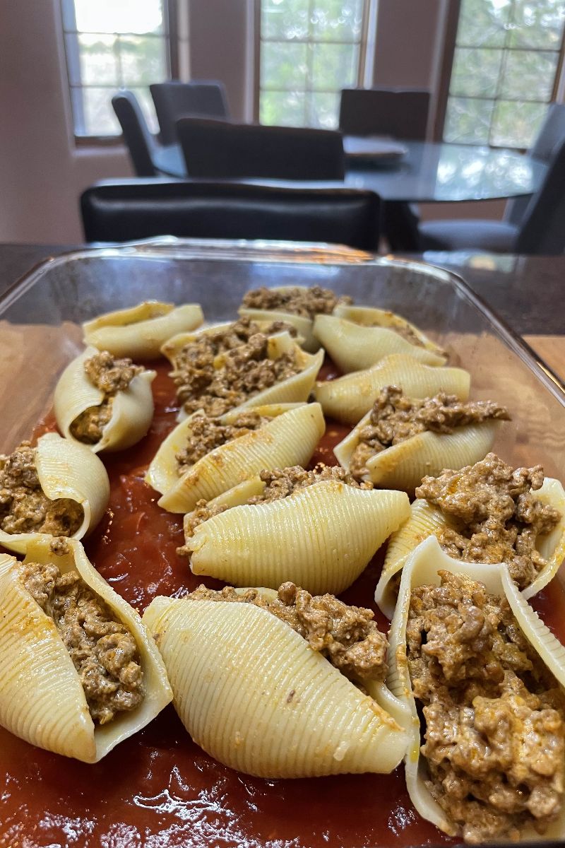 Taco stuffed shells in a baking dish. 