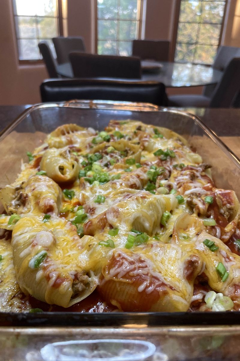 Taco stuffed shells in a baking dish.