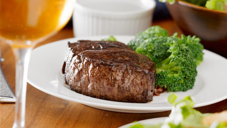 Filet mignon steak with broccoli -- steak and veggies -- on plate.