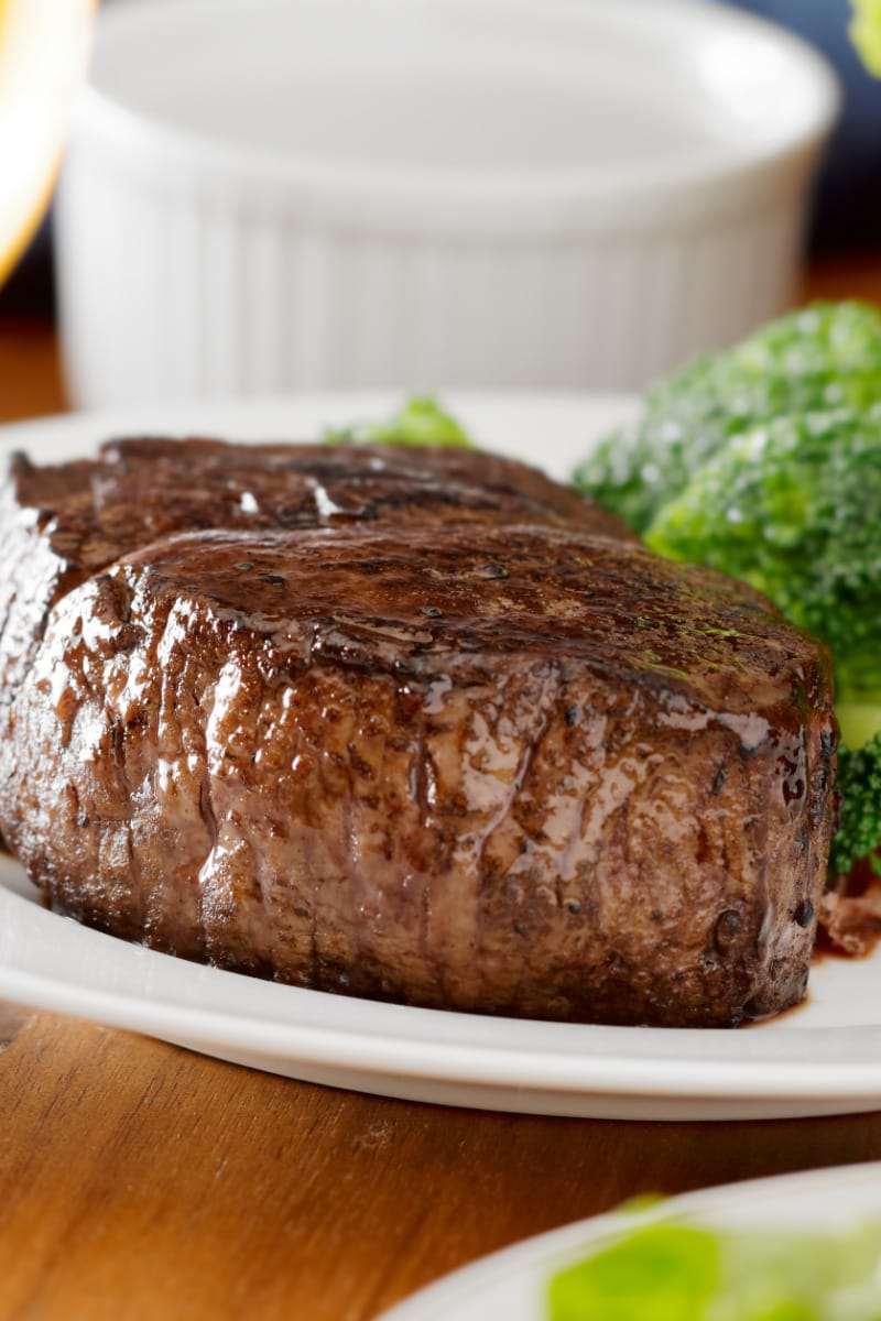 Filet mignon steak with broccoli -- steak and veggies -- on plate.