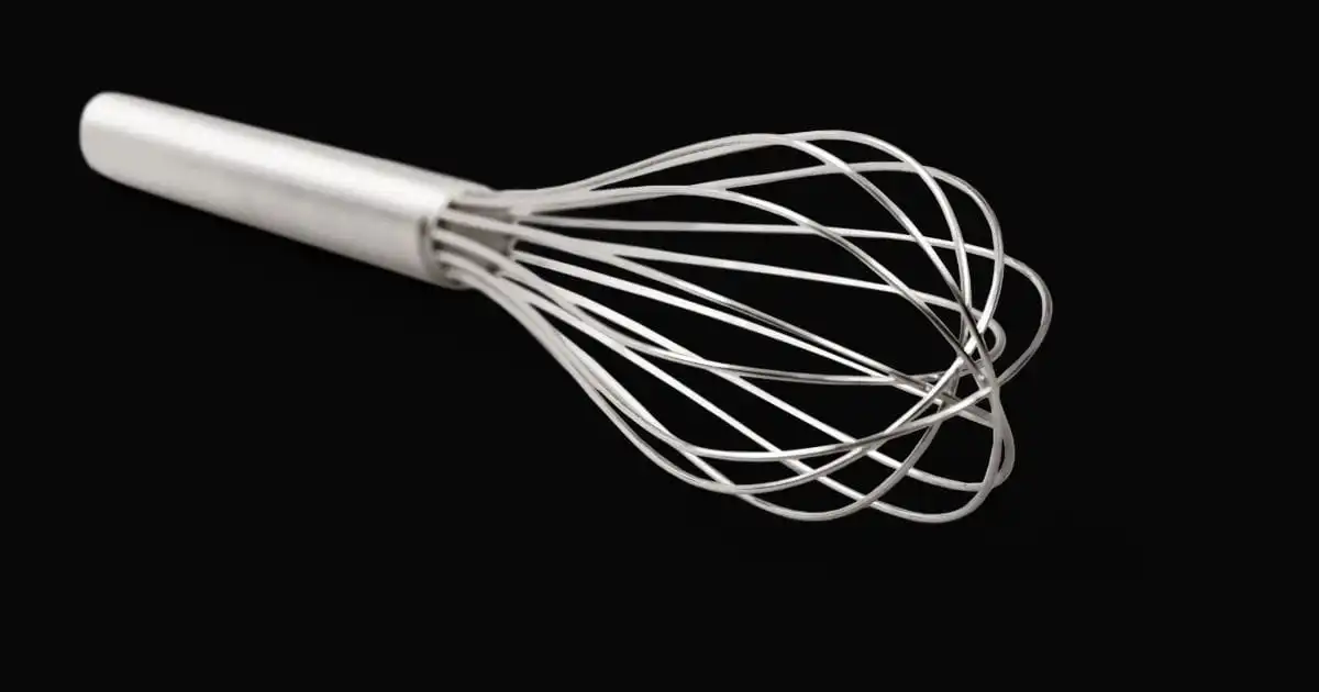 Whisk on black background.