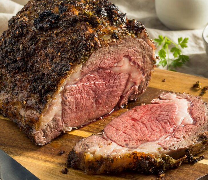 Prime rib roast in a wooden cutting board.