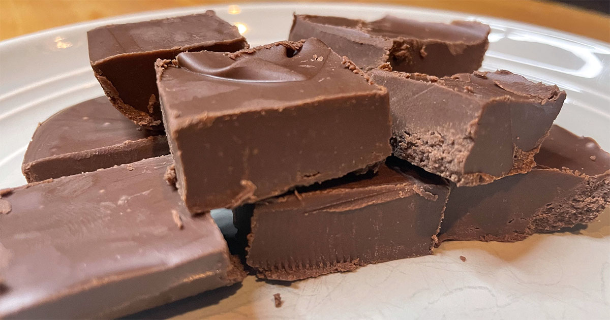 Squares of homemade easy chocolate fudge on plate.