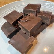 Squares of homemade easy chocolate fudge on plate.