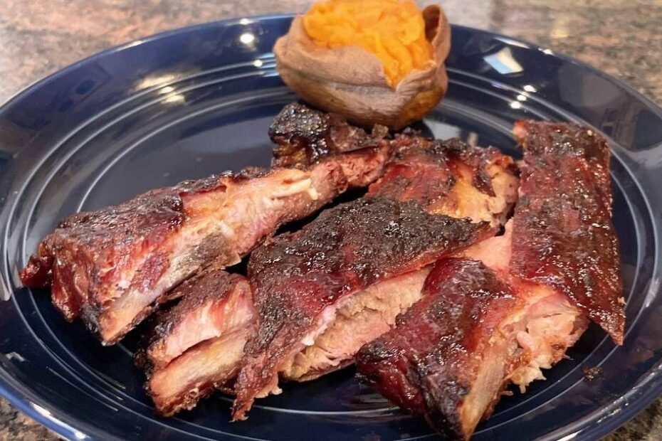 321 smoked spare ribs, prepared on plate with sweet potato.