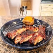 321 smoked spare ribs, prepared on plate with sweet potato.