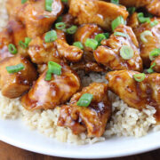 Plate of Chinatown chicken served with rice and topped with green onions
