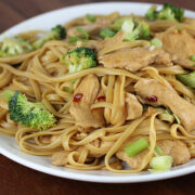 Plate of chicken and broccoli lo mein noodles with green onions