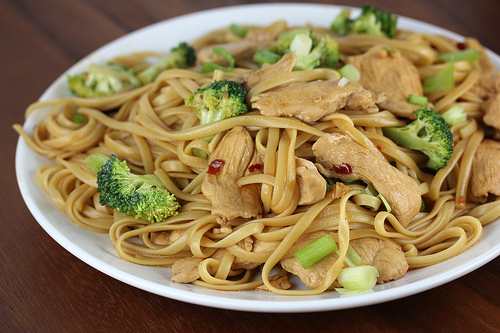 Plate of chicken and broccoli lo mein noodles with green onions