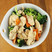 White bowl filled with chicken broccoli stir fry