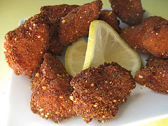 Golden brown chicken nuggets with lemon wedge