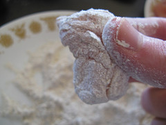 Raw chicken nugget coated in flour