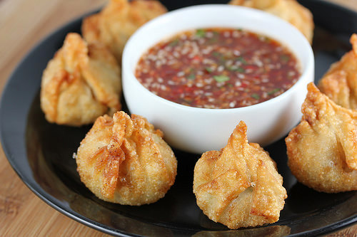 Plate of fried chicken wontons and sweet chili dipping sauce