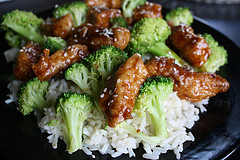 Close-up of chicken and broccoli with sesame seeds over rice