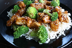 Chicken and broccoli plated with rice and sesame seeds
