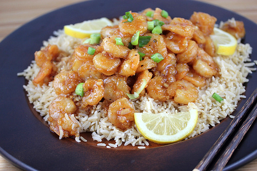 Chinese lemon pepper shrimp with rice and lemon slices