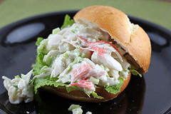 Crab salad sandwich on lettuce and a sandwich roll