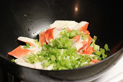 Chopped imitation crab and diced celery in a mixing bowl