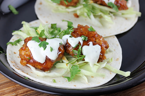 Open chicken taco with cabbage and sauce