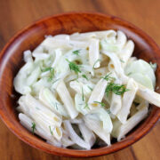 Bowl of cucumber pasta salad with penne, cucumber slices, and dill