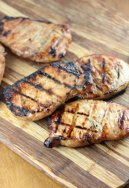 Grilled honey soy pork chops on a wooden board
