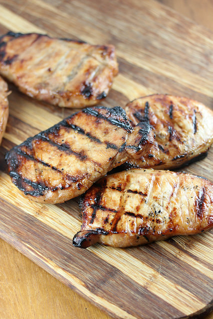 Grilled honey soy pork chops on a wooden board