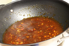 Spicy kung pao sauce simmering in a wok
