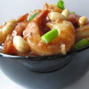 Bowl of Kung Pao shrimp with peanuts and green onions