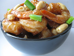 Kung Pao shrimp with peanuts and green onions in bowl