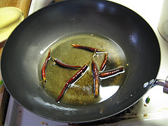 Dried red chilies frying in oil