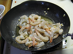 Raw shrimp cooking in wok