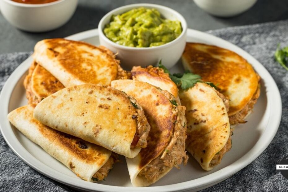 Plate of golden-brown quesadillas with guacamole