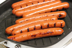 Grilled hot dogs with char marks on a stovetop grill pan