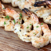 Close-up of grilled shrimp skewers sprinkled with chopped parsley