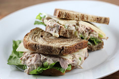 Cut tuna salad sandwich with lettuce and cheese on rye bread