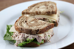 Tuna salad sandwich on rye bread with lettuce and cheese