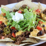 Loaded nachos with beef, cheese, lettuce, and sour cream