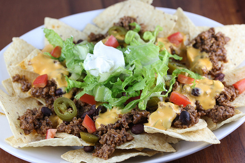 Loaded nachos with beef, cheese, lettuce, and sour cream