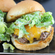 Cheddar cheeseburger topped with romaine slaw on a toasted bun