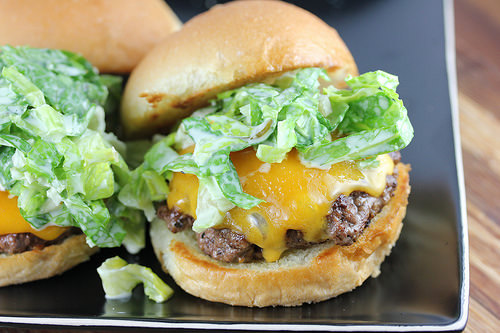 Cheddar cheeseburger topped with romaine slaw on a toasted bun