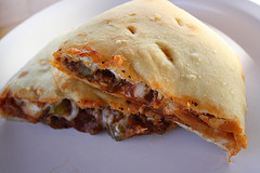 Calzone halves showing melted cheese and savory filling