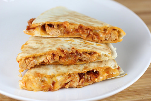 Stacked chicken tinga quesadilla slices filled with shredded chicken and melted cheese