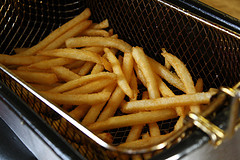 Crispy fries in a deep fryer basket