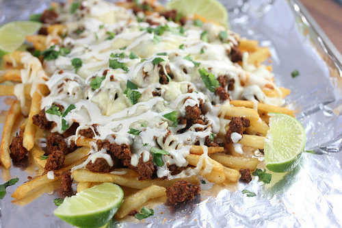 Chorizo fries topped with melted cheese and fresh cilantro