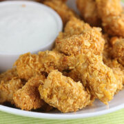 Close-up of golden chicken poppers with dipping sauce