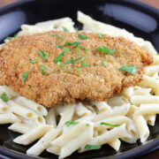 Breaded crispy chicken served over creamy penne pasta