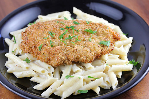 Breaded crispy chicken served over creamy penne pasta