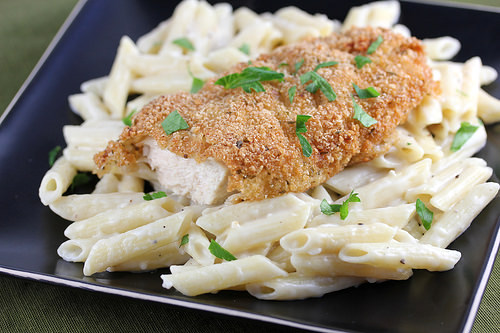 Breaded crispy chicken served over creamy penne pasta