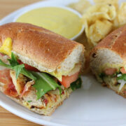 Honey mustard chicken sub served with chips and dipping sauce