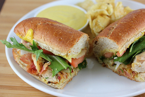 Honey mustard chicken sub served with chips and dipping sauce